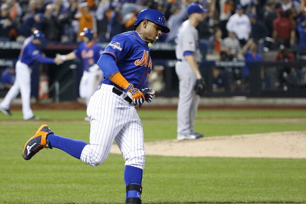 New York Mets' Yoenis Cespedes trots down the first base line after hitting a three-run home run off Los Angeles Dodgers starting pitcher Alex Wood, right, during the fourth inning of baseball's Game 3 of the National League Division Series, Monday, Oct. 12, 2015, in New York. (AP Photo/Kathy Willens)