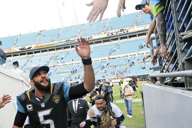 Jacksonville Jaguars quarterback Blake Bortles (5) high fives fans as he leaves the field after defeating the Indianapolis Colts 51-16 in an NFL football game in Jacksonville, Fla., Sunday, Dec. 13, 2015.  (AP Photo/Stephen B. Morton)
