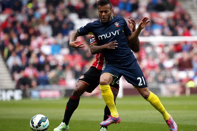 Sunderland's Jermain Defoe, left, vies for the ball with Southampton's Ryan Bertrand, right, during their English Premier League soccer match between Sunderland and Southampton at the Stadium of Light, Sunderland, England, Saturday, May 2, 2015. (AP Photo/Scott Heppell)