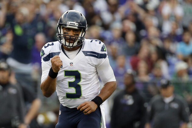 Seattle Seahawks quarterback Russell Wilson (3) celebrates a touchdown pass to Seahawks wide receiver Doug Baldwin during the second half an NFL football game against the Baltimore Ravens, Sunday, Dec. 13, 2015, in Baltimore. (AP Photo/Patrick Semansky)