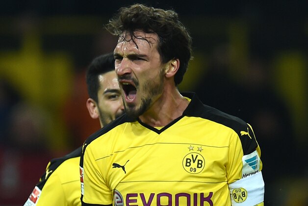 Dortmund's defender Mats Hummels celebrates during the German first division Bundesliga football match Borussia Dortmund vs Eintracht Frankfurt in Dortmund, western Germany, on December 13, 2015. Dortmund won the match 4 - 1. 
AFP PHOTO / PATRIK STOLLARZ

RESTRICTIONS: DURING MATCH TIME: DFL RULES TO LIMIT THE ONLINE USAGE TO 15 PICTURES PER MATCH AND FORBID IMAGE SEQUENCES TO SIMULATE VIDEO. == RESTRICTED TO EDITORIAL USE == FOR FURTHER QUERIES PLEASE CONTACT DFL DIRECTLY AT + 49 69 650050. / AFP / PATRIK STOLLARZ        (Photo credit should read PATRIK STOLLARZ/AFP/Getty Images)