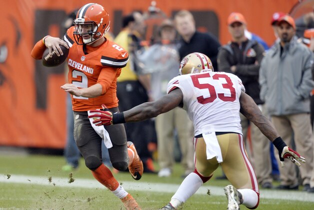 Cleveland Browns quarterback Johnny Manziel (2) avoids a tackle by San Francisco 49ers inside linebacker NaVorro Bowman (53) during the second half of an NFL football game, Sunday, Dec. 13, 2015, in Cleveland. (AP Photo/David Richard)