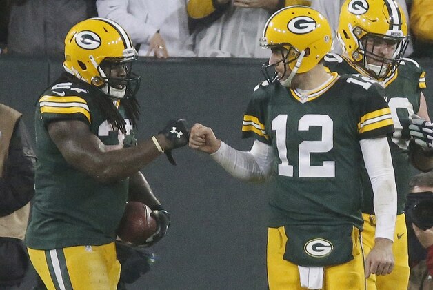 Green Bay Packers' Eddie Lacy is congratulated by Aaron Rodgers (12) after Lacy's touchdown run during the second half of an NFL football game against the Dallas Cowboys Sunday, Dec. 13, 2015, in Green Bay, Wis. (AP Photo/Mike Roemer)