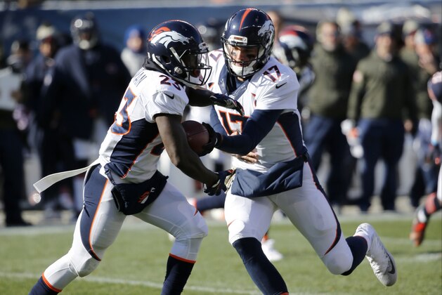 Denver Broncos quarterback Brock Osweiler (17) hands off the ball to running back Ronnie Hillman (23) during the first half of an NFL football game against the Chicago Bears, Sunday, Nov. 22, 2015, in Chicago. (AP Photo/Charles Rex Arbogast)