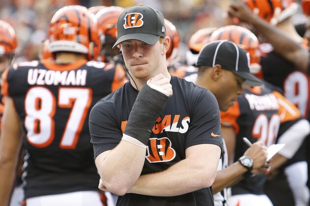Cincinnati Bengals quarterback Andy Dalton walks the sidelines in a cast on his throwing hand after being taken out of the game with an injury in the first half of an NFL football game against the Pittsburgh Steelers, Sunday, Dec. 13, 2015, in Cincinnati. (AP Photo/Frank Victores)