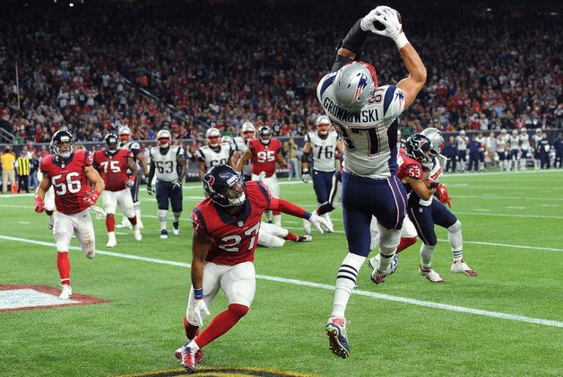New England Patriots tight end Rob Gronkowski (87) catches a pass for a touchdown over Houston Texans strong safety Quintin Demps (27) during the first hall of an NFL football game Sunday,  Dec. 13, 2015, in Houston. (AP Photo/George Bridges)