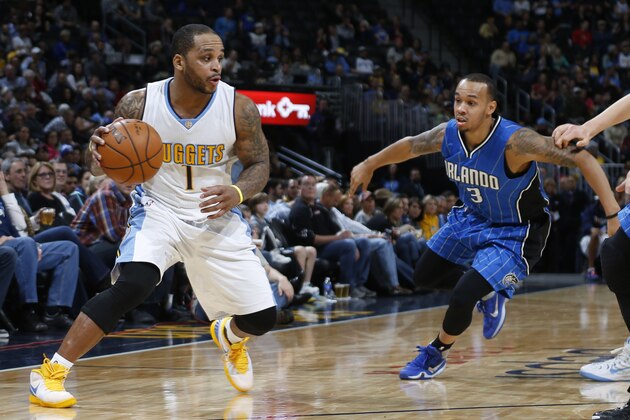 Denver Nuggets guard Jameer Nelson (1), left, picks up loose ball as Orlando Magic guard Shabazz Napier (13) defends in the second half of an NBA basketball game Tuesday, Dec. 8, 2015, in Denver. Orlando won 85-74. (AP Photo/David Zalubowski)