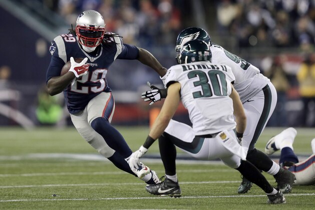 New England Patriots running back LeGarrette Blount (29) runs from Philadelphia Eagles safety Ed Reynolds (30) during the first half of an NFL football game, Sunday, Dec. 6, 2015, in Foxborough, Mass. (AP Photo/Charles Krupa)