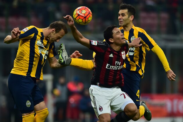 AC Milan's forward from Colombia Carlos Bacca (C) fights for the ball with Hellas Verona's defender from Mexico Rafael Marquez during the Italian Seria A football match AC Milan vs Hellas Verona at San Siro Stadium in Milan on December 13, 2015 . AFP PHOTO / GIUSEPPE CACACE / AFP / GIUSEPPE CACACE        (Photo credit should read GIUSEPPE CACACE/AFP/Getty Images)