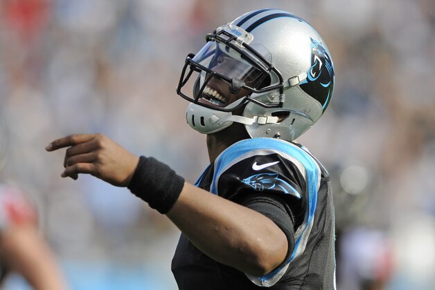 Carolina Panthers' Cam Newton (1) reacts as he watches a video board during a timeout in the first half of an NFL football game against the Atlanta Falcons in Charlotte, N.C., Sunday, Dec. 13, 2015. (AP Photo/Mike McCarn)