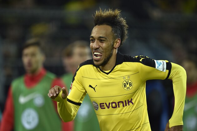 Dortmund's Pierre-Emerick Aubameyang  celebrates after scoring during the German Bundesliga soccer match between Borussia Dortmund and Eintracht Frankfurt in Dortmund, Germany, Sunday, Dec. 13, 2015. Dortmund defeated Frankfurt with 4-1. (AP Photo/Martin Meissner)