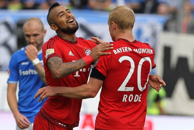Bayern Munich's midfielder Sebastian Rode (R) celebrates with his teammate Bayern Munich's Chilean midfielder Arturo Vidal after scoring the 3-0 during the German first division Bundesliga football match SV Darmstadt 98 vs FC Bayern Munich in Darmstadt, western Germany on September 19, 2015.  AFP PHOTO / DANIEL ROLAND  RESTRICTIONS: DURING MATCH TIME: DFL RULES TO LIMIT THE ONLINE USAGE TO 15 PICTURES PER MATCH AND FORBID IMAGE SEQUENCES TO SIMULATE VIDEO.  == RESTRICTED TO EDITORIAL USE ==  FOR FURTHER QUERIES PLEASE CONTACT DFL DIRECTLY AT + 49 69 650050.        (Photo credit should read DANIEL ROLAND/AFP/Getty Images)