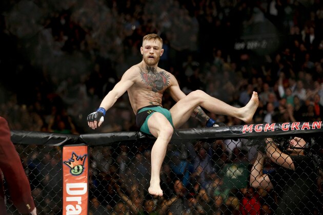 Conor McGregor reacts after defeating Jose Aldo during a featherweight  championship mixed martial arts bout at UFC 194, Saturday, Dec. 12, 2015, in Las Vegas. (AP Photo/John Locher)
