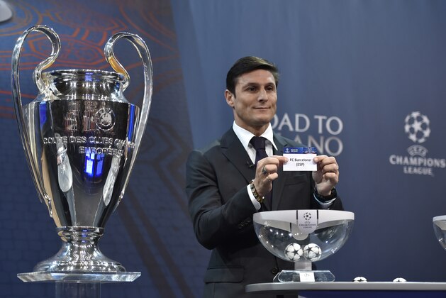 UEFA Champions League final ambassador  Javier Zanetti  shows the name of FC Barcelona football club during the draw for the UEFA Champions league round of sixteen, on December 14, 2015 at the UEFA headquarters in Nyon.  AFP PHOTO / FABRICE COFFRINI / AFP / FABRICE COFFRINI        (Photo credit should read FABRICE COFFRINI/AFP/Getty Images)
