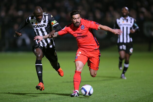 Paris Saint Germain's forward Ezequiel lavezzi of Argentina, right, challenges for the ball with Angers' defender Cheick Ndoye of Senegal during their French League One soccer match, Tuesday, Dec. 1, 2015, in Angers, western France. Match ended on a 0-0 draw. (AP Photo/David Vincent)