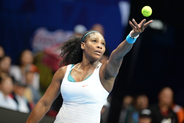 US tennis player Serena Williams  of the Philippine Mavericks serves against Australias Samantha Stosur of the Indian Aces in the women's singles of the International Premier Tennis League (IPTL) competition in Manila on December 8, 2015. Williams won 6-3.     AFP PHOTO / TED ALJIBE / AFP / TED ALJIBE        (Photo credit should read TED ALJIBE/AFP/Getty Images)