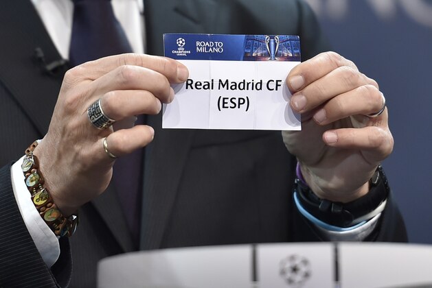 UEFA Champions League final ambassador  Javier Zanetti shows the name of Real Madrid during the draw for the UEFA Champions league round of sixteen, on December 14, 2015 at the European football organization's headquarters in Nyon.  AFP PHOTO / FABRICE COFFRINI / AFP / FABRICE COFFRINI        (Photo credit should read FABRICE COFFRINI/AFP/Getty Images)