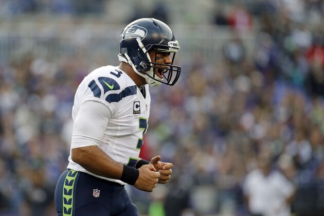 Seattle Seahawks quarterback Russell Wilson reacts after throwing a touchdown pass during an NFL football game against the Baltimore Ravens, Sunday, Dec. 13, 2015, in Baltimore. (AP Photo/Patrick Semansky)