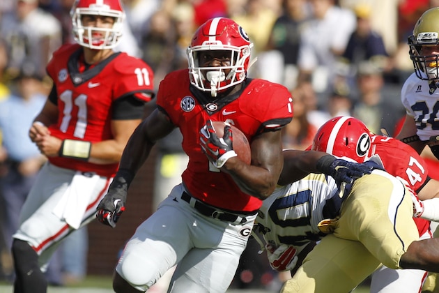 Georgia running back Sony Michel (1) runs for a touchdown as Georgia Tech linebacker Tyler Marcordes (35), defensive end KeShun Freeman (42), and linebacker Brant Mitchell (51) look on in the first half of an NCAA college football game Saturday, Nov. 28, 2015, in Atlanta. (AP Photo/Brett Davis) Georgia running back Sony Michel (1) runs for a touchdown as Georgia Tech linebacker Tyler Marcordes (35), defensive end KeShun Freeman (42), and linebacker Brant Mitchell (51) look on in the first half of an NCAA college football game Saturday, Nov. 28, 2015, in Atlanta. (AP Photo/Brett Davis)