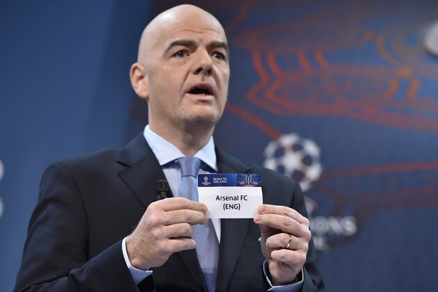 UEFA General Secretary  Gianni Infantino  shows the name of Arsenal football club during the draw for the UEFA Champions league round of sixteen, on December 14, 2015 at the UEFA headquarters in Nyon.  AFP PHOTO / FABRICE COFFRINI / AFP / FABRICE COFFRINI        (Photo credit should read FABRICE COFFRINI/AFP/Getty Images)