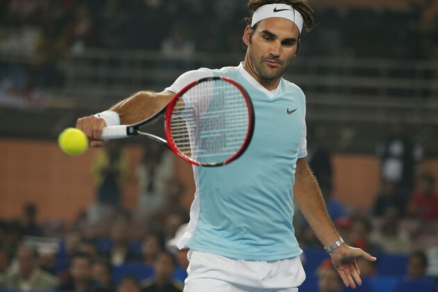 Roger Federer of UAE Royal returns a shot to Rafael Nadal of Indian Aces in the men's singles event of the International Premier Tennis League in New Delhi, India, Saturday, Dec. 12, 2015. (AP Photo/Tsering Topgyal)