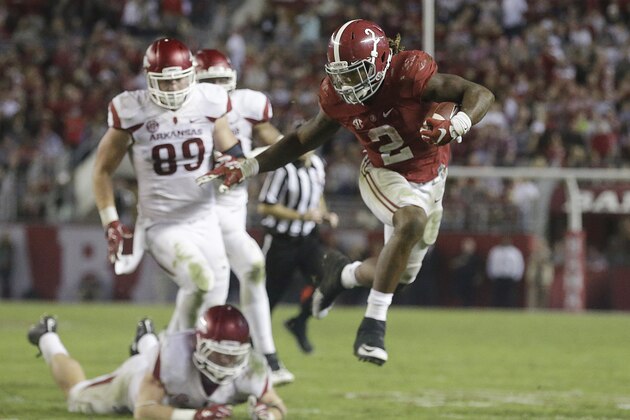 File - In this  Saturday, Oct. 10, 2015, file photo, Alabama running back Derrick Henry (2) jumps and runs the ball against Arkansas in the second half of an NCAA college football game, in Tuscaloosa, Ala. Henry bulldozed defenses while carrying Alabama's offense this season, and then walked away with a Heisman Trophy. The Crimson Tide's super-sized tailback won college football's most famous player of the year award Saturday, Dec. 12, 2015, becoming just the third running back to take the Heisman in the last 16 years.