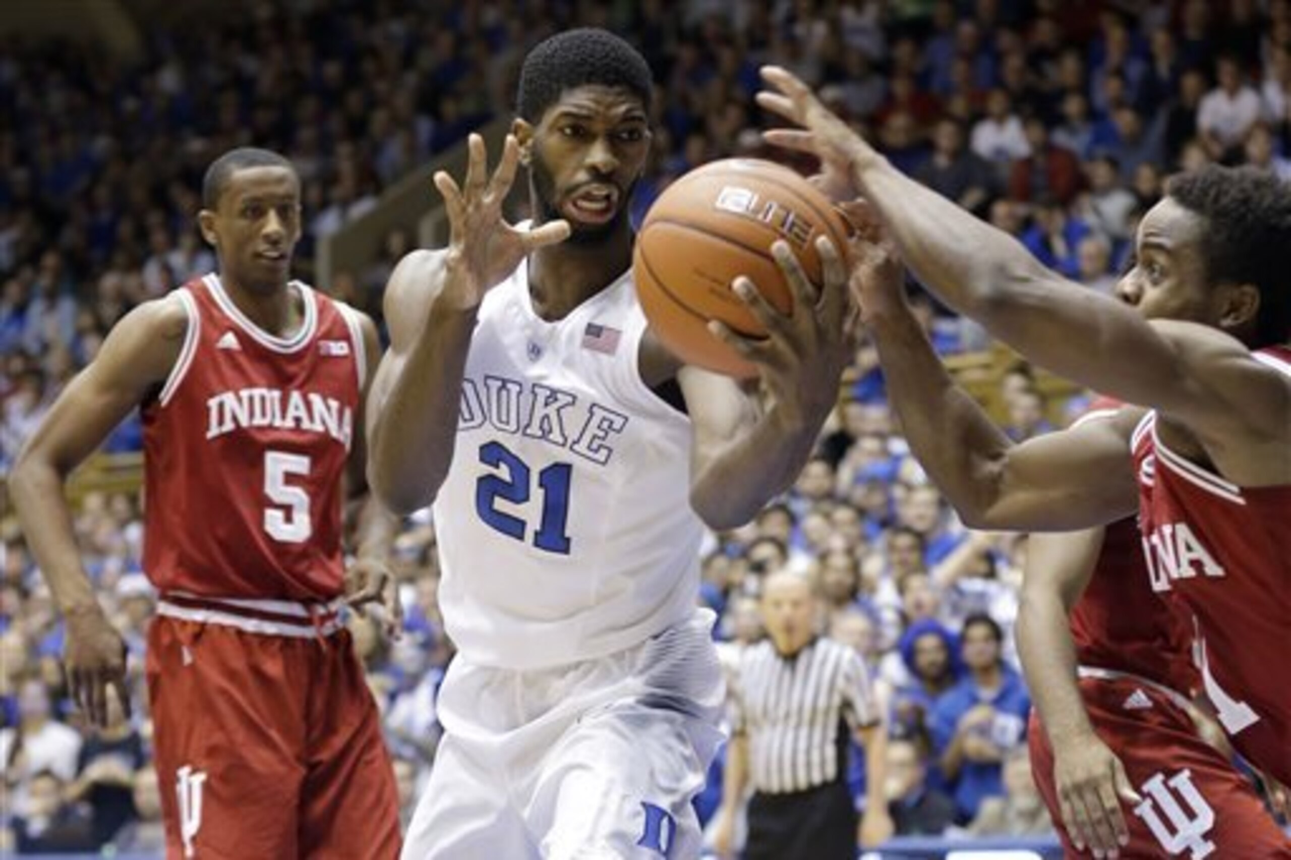 Duke's Amile Jefferson (21) reaches for the ball as Indiana's Troy Williams (5) watches and Yogi Ferrell, right, reaches during the first half of an NCAA college basketball game in Durham, N.C., Wednesday, Dec. 2, 2015. (AP Photo/Gerry Broome)