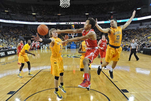 WICHITA, KS - DECEMBER 12:  Guard Brandon Taylor #11 of the Utah Utes passes the ball between defenders Fred VanVleet #23 and Ron Baker #31 of the Wichita State Shockers during the first half on December 12, 2015 at Intrust Bank Arena in Wichita, Kansas.  Wichita State defeated Utah 67-50. (Photo by Peter Aiken/Getty Images)