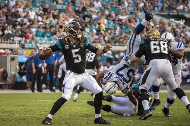 Jacksonville Jaguars quarterback Blake Bortles (5) looks for a receiver as he is pressured by Indianapolis Colts inside linebacker Josh McNary (57) during the second half of an NFL football game in Jacksonville, Fla., Sunday, Dec. 13, 2015. Jacksonville won 51-16. (AP Photo/Stephen B. Morton)