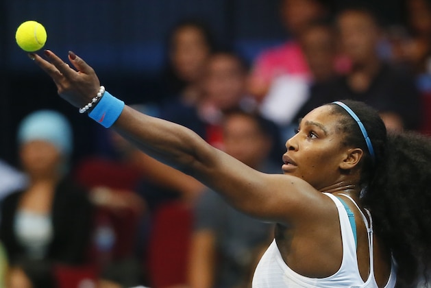 USA's Serena Williams of the Philippine Mavericks serves to Australia's Samantha Stosur of the Indian Aces during the women's singles in the  2015 International Premier Tennis League Tuesday, Dec. 8, 2015 at the Mall of Asia Arena at suburban Pasay city south of Manila, Philippines. Williams won 6-3. (AP Photo/Bullit Marquez)