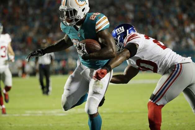 Miami Dolphins running back Lamar Miller (26) breaks a tackle by New York Giants cornerback Prince Amukamara (20) to score a touchdown during the first half of an NFL football game, Monday, Dec. 14, 2015, in Miami Gardens, Fla. (AP Photo/Wilfredo Lee) Miami Dolphins running back Lamar Miller (26) breaks a tackle by New York Giants cornerback Prince Amukamara (20) to score a touchdown during the first half of an NFL football game, Monday, Dec. 14, 2015, in Miami Gardens, Fla. (AP Photo/Wilfredo Lee)