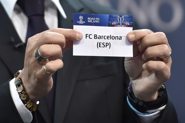 UEFA Champions League final ambassador  Javier Zanetti  shows the name of FC Barcelona football club during the draw for the UEFA Champions league round of sixteen, on December 14, 2015 at the UEFA headquarters in Nyon.  AFP PHOTO / FABRICE COFFRINI / AFP / FABRICE COFFRINI        (Photo credit should read FABRICE COFFRINI/AFP/Getty Images)