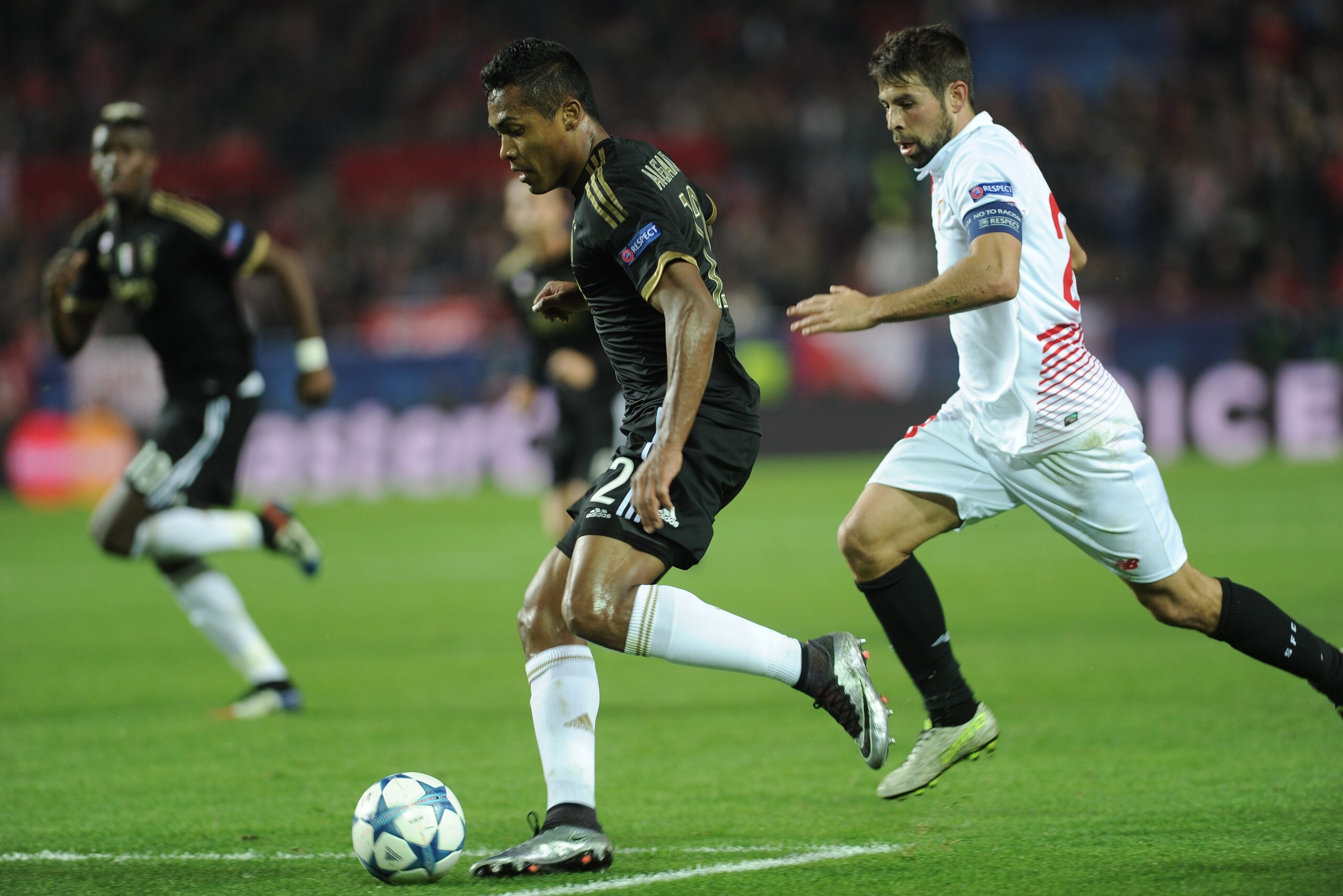 Sevilla's defender Coke (R) vies with Juventus' Brazilian defender Alex Sandro Lobo during the UEFA Champions League Group D football match Sevilla FC vs Juventus at the Ramon Sanchez Pizjuan stadium in Sevilla on December 8, 2015. Sevilla won 1-0.   AFP PHOTO/ CRISTINA QUICLER / AFP / CRISTINA QUICLER        (Photo credit should read CRISTINA QUICLER/AFP/Getty Images)