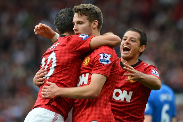 Manchester United's English midfielder Nick Powell (2nd L) celebrates scoring his goal with team-mates during the English Premier League football match between Manchester United and Wigan Athletic at Old Trafford in Manchester, north-west England on September 15, 2012. AFP PHOTO/PAUL ELLIS

RESTRICTED TO EDITORIAL USE. No use with unauthorized audio, video, data, fixture lists, club/league logos or “live” services. Online in-match use limited to 45 images, no video emulation. No use in betting, games or single club/league/player publications        (Photo credit should read PAUL ELLIS/AFP/GettyImages)