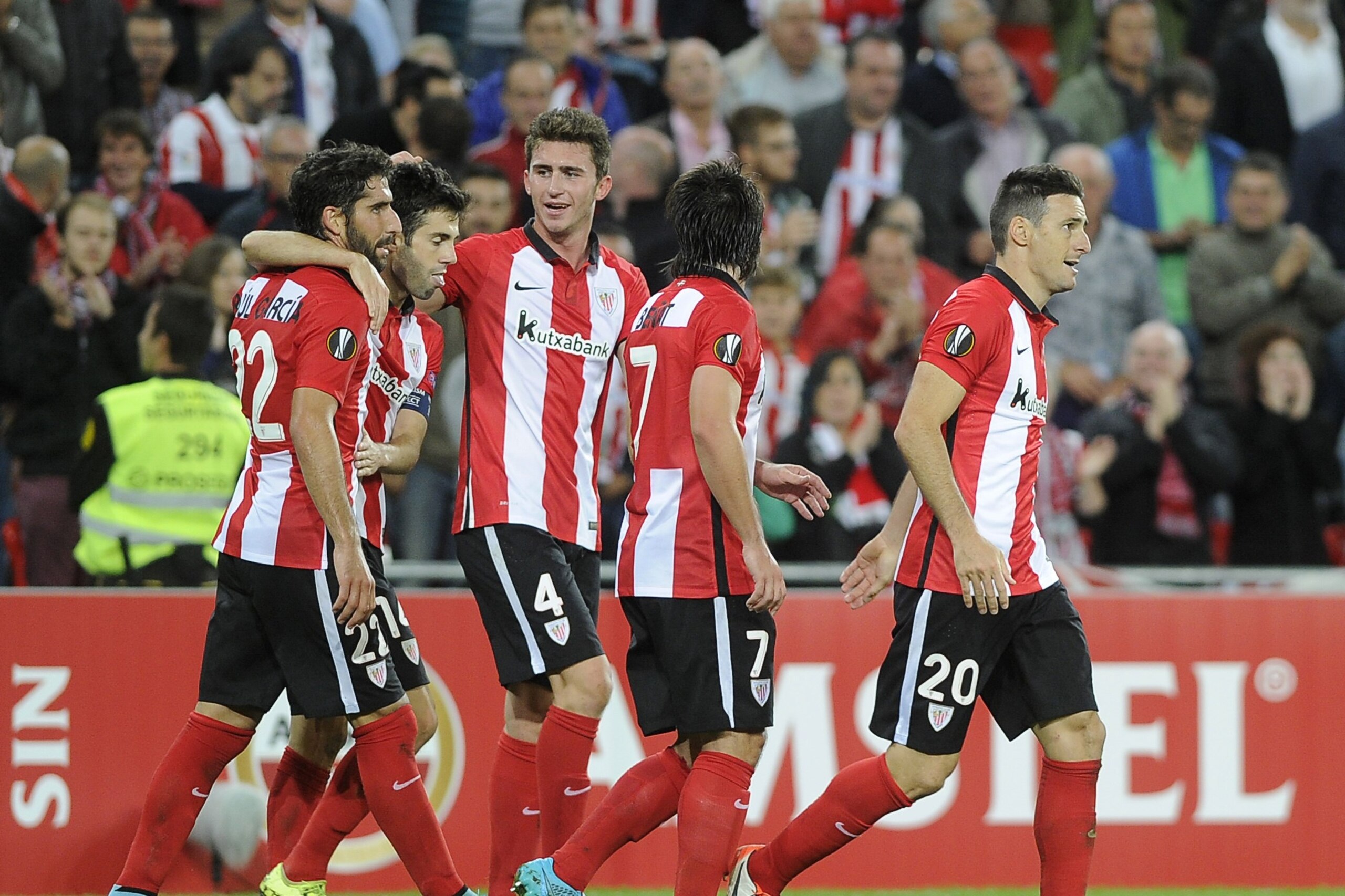 Athletic Bilbao's forward Aritz Aduriz (R) celebrates with French defender Aymeric Laporte (C) and teammates scoring during the UEFA Europa League group L football match Athletic Club Bilbao vs FC Ausburg at the San Mames stadium in Bilbao on September 17, 2015.   AFP PHOTO/ ANDER GILLENEA        (Photo credit should read ANDER GILLENEA/AFP/Getty Images)