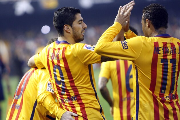 FC Barcelona's Luis Suarez, center, celebrates after scored with his teammates Messi, left, and Neymar during a Spanish La Liga soccer match against celebrates after scoring against Valencia during a Spanish La Liga soccer match at the Mestalla stadium in Valencia, Spain, Saturday, Dec. 5, 2015. (AP Photo/Alberto Saiz)