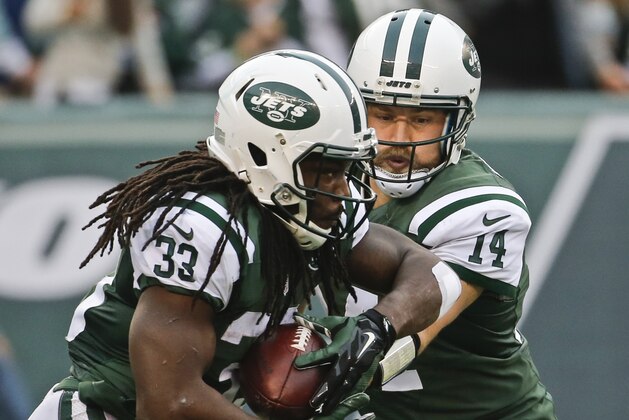 New York Jets quarterback Ryan Fitzpatrick (14) hands the ball to Chris Ivory (33) during the second half of an NFL football game against the Tennessee Titans Sunday, Dec. 13, 2015, in East Rutherford, N.J.  (AP Photo/Julio Cortez)
