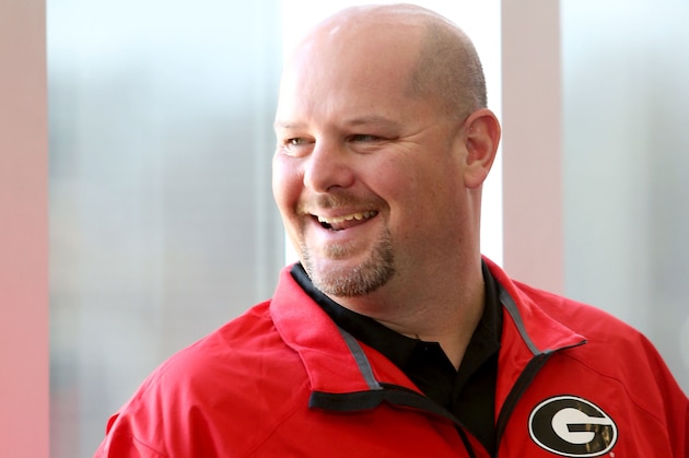 Georgia defensive assistant Kevin Sherrer laughs with fellow coaches during a meeting with Georgia fans discussing Georgia's recruiting class on national signing day Wednesday, Feb. 5, 2014, in Athens, Ga. (AP Photo/Jason Getz)