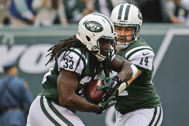 New York Jets quarterback Ryan Fitzpatrick (14) hands the ball to Chris Ivory (33) during the second half of an NFL football game against the Tennessee Titans Sunday, Dec. 13, 2015, in East Rutherford, N.J.  (AP Photo/Julio Cortez)