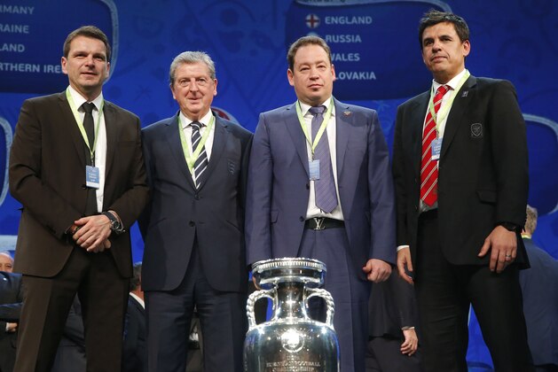 The coaches of teams drawn in group B, from left: Slovakia's assistant coach Stefan Tarkovic, England soccer team coach Roy Hodgson, Russian coach Leonid Slutski and Chris Coleman, the coach of Wales pose for a photo after the Euro 2016 soccer championships draw in Paris Saturday, Dec. 12, 2015.  (AP Photo/Michel Euler)