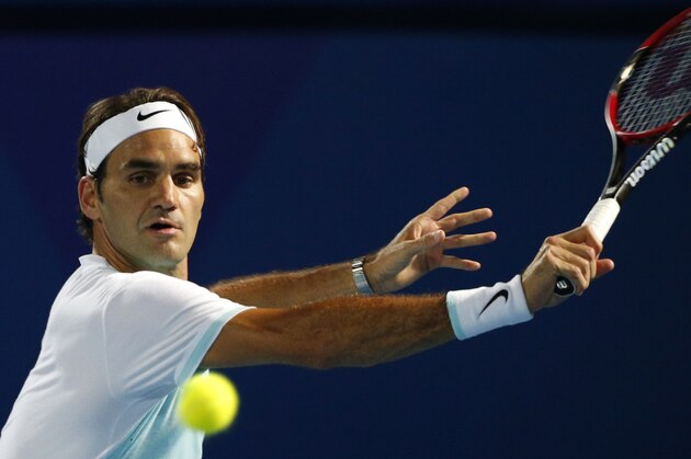 Switzerland's Roger Federer of Obi UAE Royals returns the ball to Croatia's Ivo Karlovic of Philippine Mavericks during their International Premier Tennis League (IPTL) tennis match on December 14, 2015 in the Emirate Dubai. AFP PHOTO / KARIM SAHIB / AFP / KARIM SAHIB        (Photo credit should read KARIM SAHIB/AFP/Getty Images)