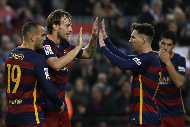 Barcelona's Ivan Rakitic, left, celebrates scoring his side's second goal with teammate Lionel Messi, right, during a Spanish La Liga soccer match between FC Barcelona and Deportivo Coruna at the Camp Nou stadium in Barcelona, Spain, Saturday, Dec. 12, 2015. (AP Photo/ Emilio Morenatti)