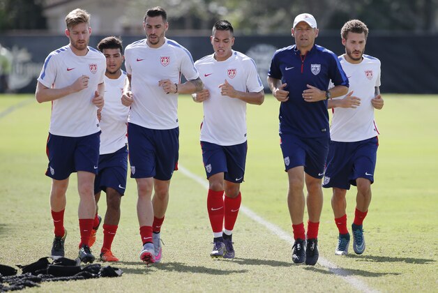 U.S. men's national soccer team coach Jurgen Klinsmann, second from right, jogs around the field with players during practice, Monday, Nov. 9, 2015, at Barry University in Miami Shores, Fla. The team plays Friday in St. Louis against St. Vincent and the Grenadines, then plays four days later at Trinidad and Tobago. Klinsmann brought the team to Barry University, wanting two days of training in heat and humidity ahead of next week's game in Port-of-Spain. (AP Photo/Wilfredo Lee)