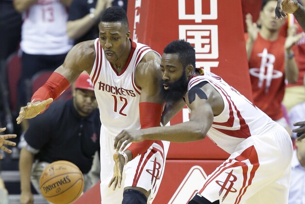 Houston Rockets Dwight Howard (12) and James Harden go after a loose ball in an NBA basketball game against the Orlando Magic Wednesday, Nov. 4, 2015, in Houston. (AP Photo/Pat Sullivan)