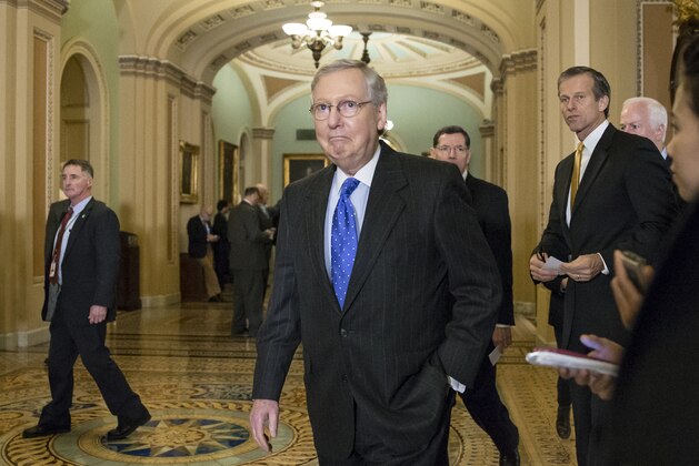 Senate Majority Leader Mitch McConnell, R-Ky., followed by Sen. John Barrasso, R-Wyo., Sen. John Thune, R-S.D., and Majority Whip John Cornyn, R-Texas, leaves a closed-door party caucus to update reporters as White House and congressional negotiators move closer to clinching a tax and spending compromise extend numerous tax credits and fund government agencies in 2016, at the Capitol in Washington, Tuesday, Dec. 15, 2015. Current government funding runs out Wednesday at midnight and Congress may need to pass another short-term extension of a day or two before striking a final agreement and leaving for the holiday break. (AP Photo/J. Scott Applewhite)