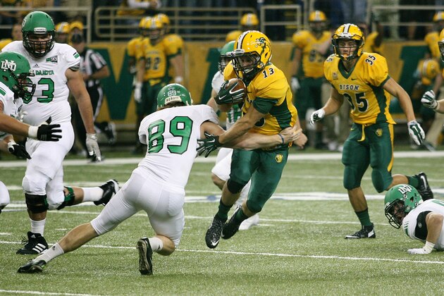 North Dakota State receiver Eric Perkins, right, eludes North Dakota defender Mitch Meindel, (89) during the second half of an NCAA college football game Saturday, Sept. 19, 2015, in Fargo, N.D.  North Dakota State won 34-9. (AP Photo/Bruce Crummy)