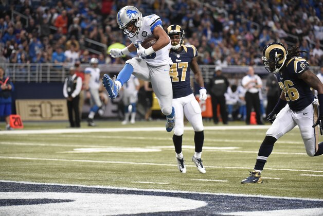 Detroit Lions wide receiver Golden Tate, left, leaps into the end zone past St. Louis Rams cornerback Marcus Roberson after catching a 9-yard pass for a touchdown during the third quarter of an NFL football game Sunday, Dec. 13, 2015, in St. Louis. (AP Photo/L.G. Patterson)