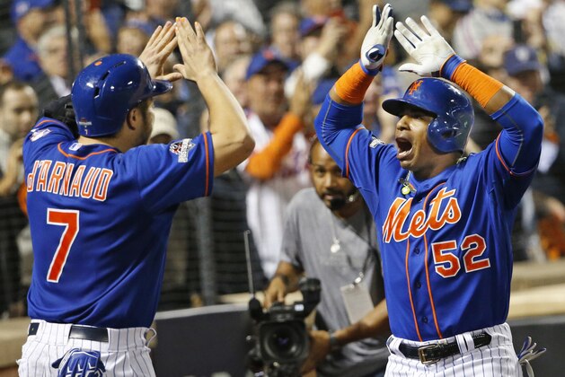New York Mets' Travis d'Arnaud (7) greets Yoenis Cespedes (52) after Cespedes hit a fourth-inning, three-run home run during baseball's Game 3 of the National League Division Series, Monday, Oct. 12, 2015, in New York. (AP Photo/Kathy Willens)