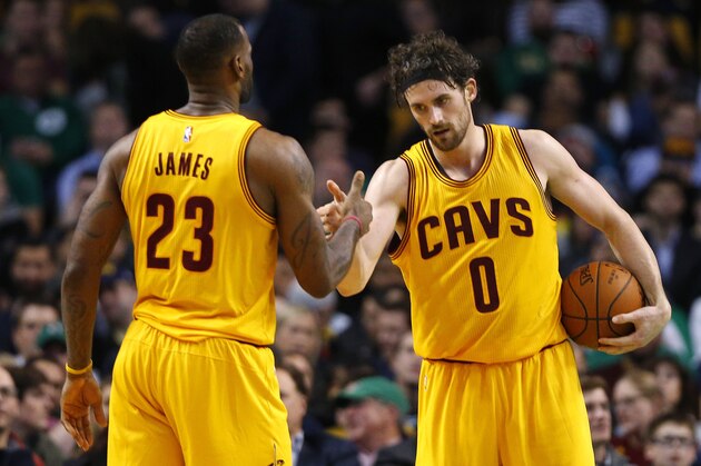 Cleveland Cavaliers' LeBron James and Kevin Love (0) congratulate each other during the fourth quarter of the Cleveland Cavaliers 89-77 win over the Boston Celtics in a NBA basketball game in Boston Tuesday, Dec. 15, 2015. (AP Photo/Winslow Townson)