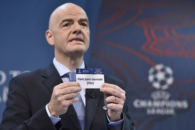 UEFA General Secretary  Gianni Infantino  shows the name of Paris Saint-Germain during the draw for the UEFA Champions league round of sixteen, on December 14, 2015 at the European football organization's headquarters in Nyon.  AFP PHOTO / FABRICE COFFRINI / AFP / FABRICE COFFRINI        (Photo credit should read FABRICE COFFRINI/AFP/Getty Images)